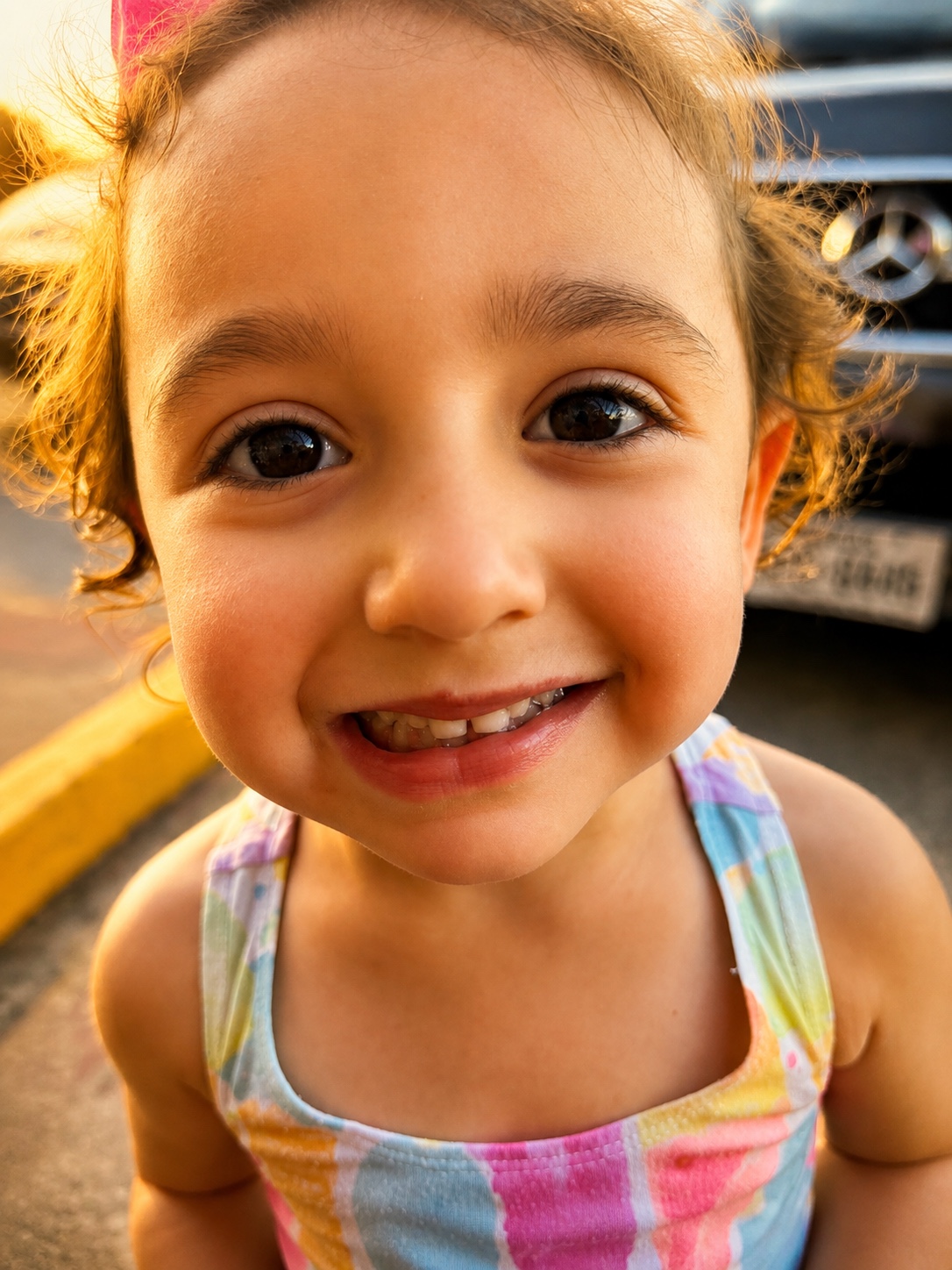 Close-up portrait of a smiling child in golden light